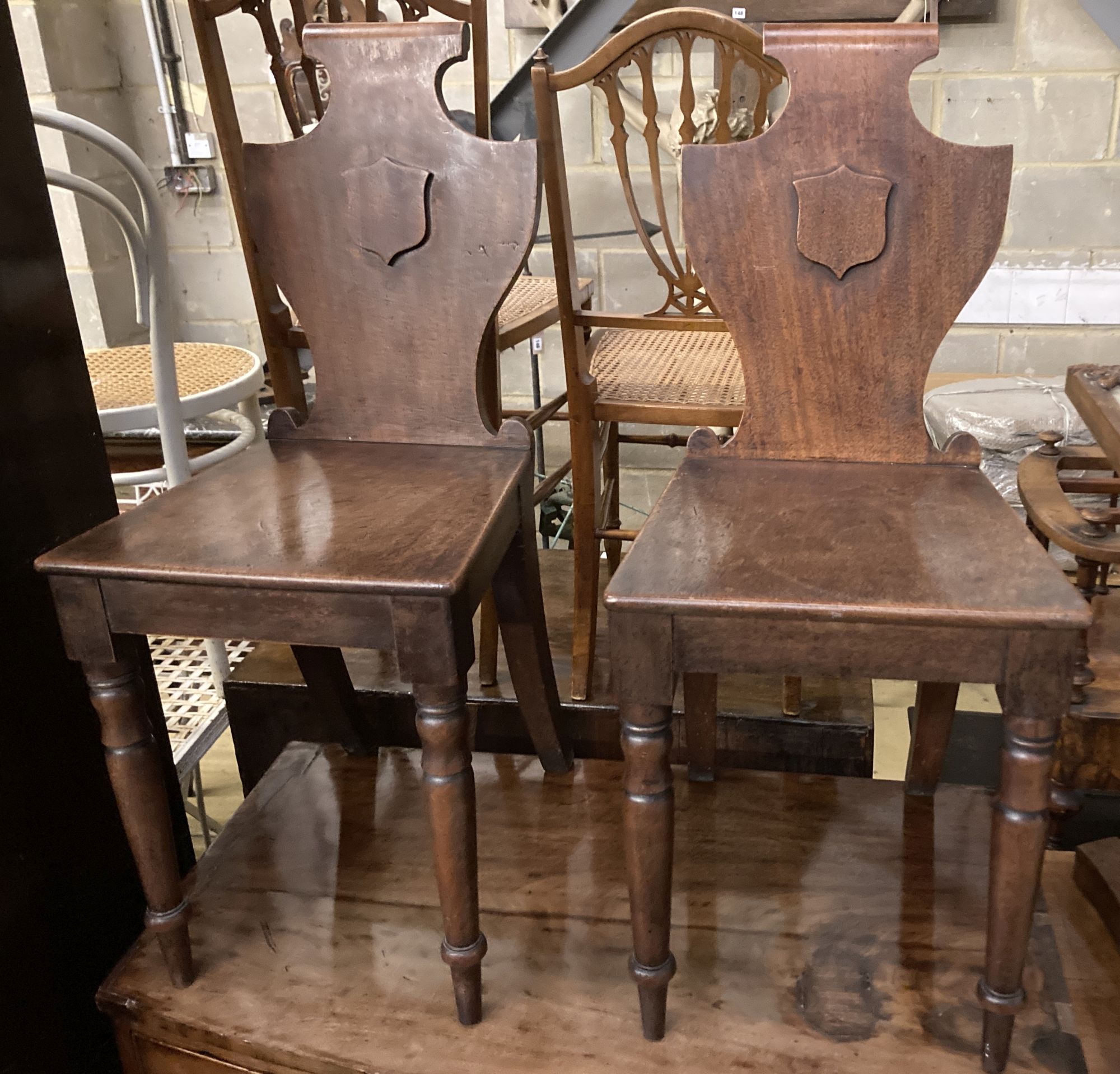 A pair of Victorian mahogany hall chairs